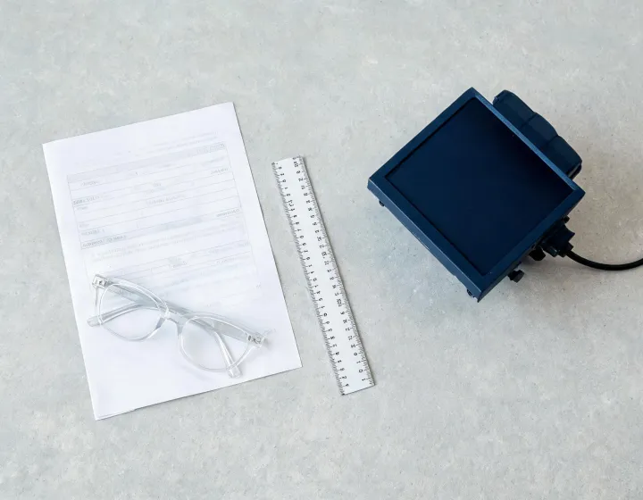 Requirement sheet beside clear glasses frames for women